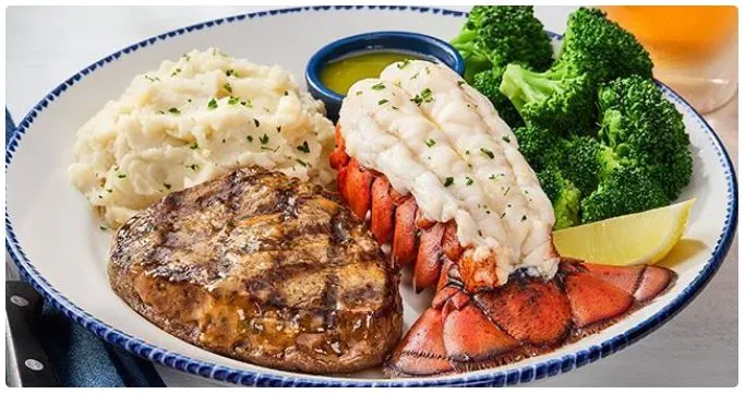 Red Lobster Surf & Turf plate: Maine lobster tail, 7 oz sirloin, rice & broccoli; 2026 price $46, 740 cal.