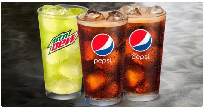 Cold fountain drinks served in cups with ice and fizzy soda