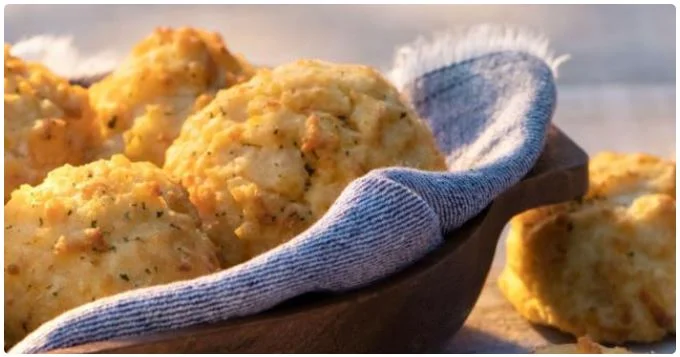 warm biscuits served with butter and extra sides.