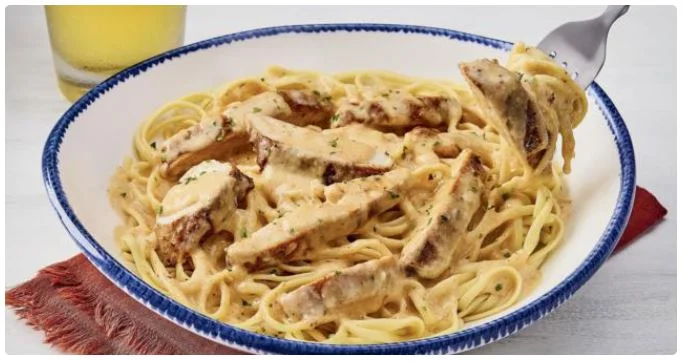 creamy white sauce pasta served in a bowl.